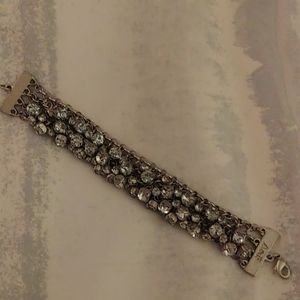 Silver 6" bracelet with rhinestones on it.